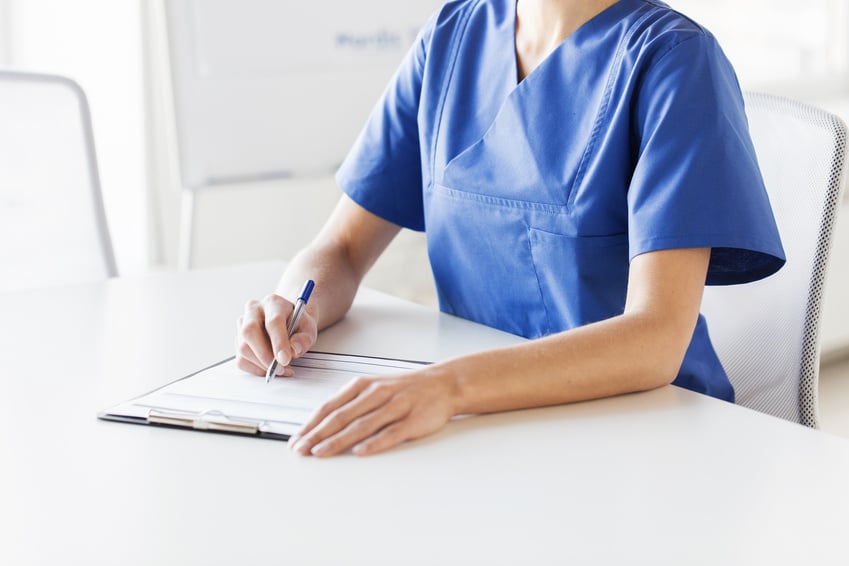 Nurse Writing to Clipboard